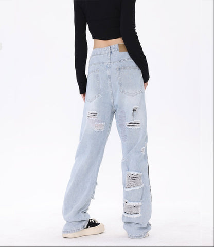Close-up of ripped details on light blue denim